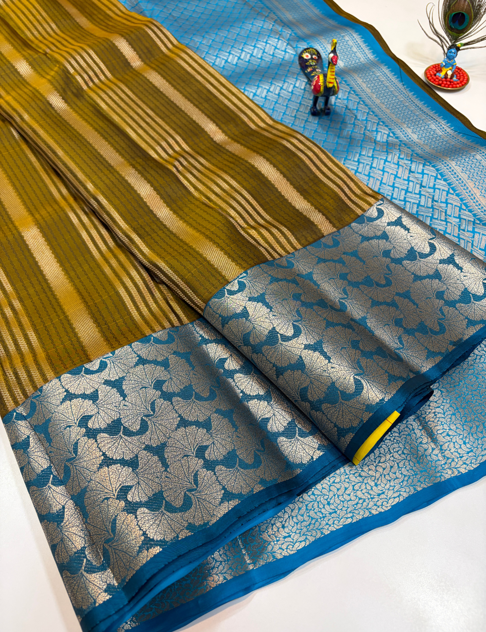 50% Pure Mix Silk Saree – Olive Mustard with Peacock Blue Contrast Pallu & Antique Gold Brocade Border | Emboss Design Body